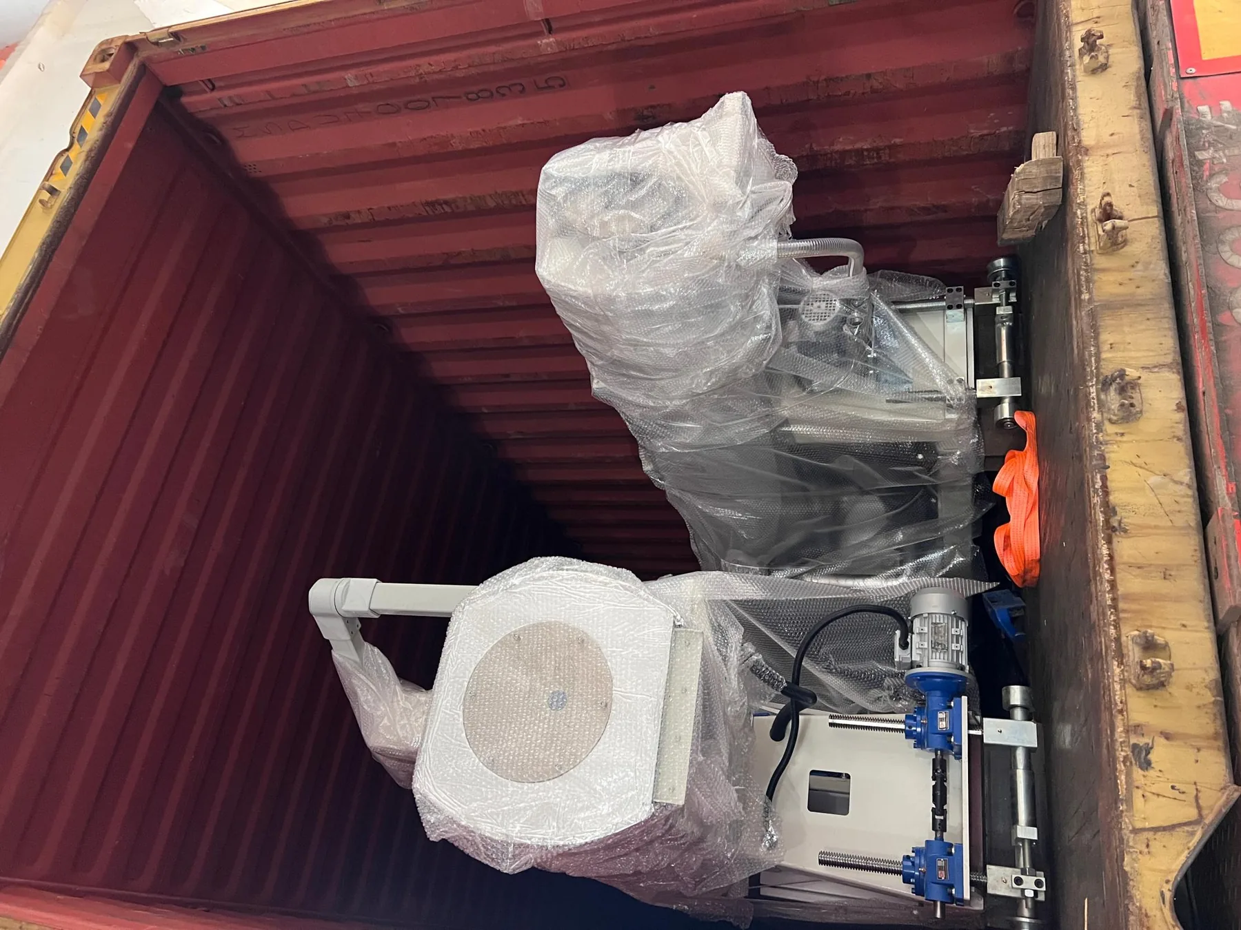 Wrapped haul-off machine secured inside the container